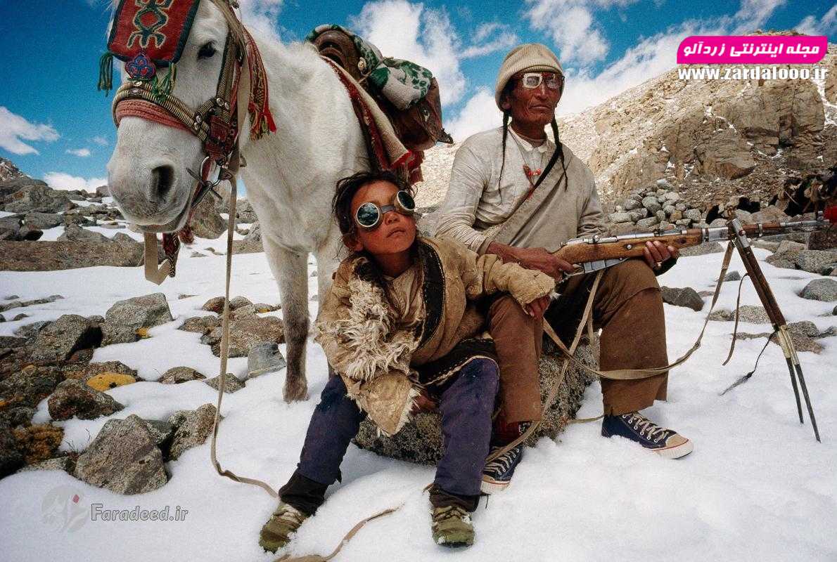 یک پدر و پسر در حال استراحت کنار اسبشان در سفر به اطراف کوه کایلاس در تبت